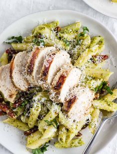 a white plate topped with pasta and chicken