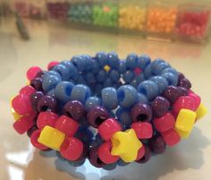 a bracelet made out of plastic beads on a table