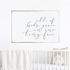 a white crib with a framed quote above it