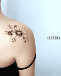 a woman with a sunflower tattoo on her shoulder