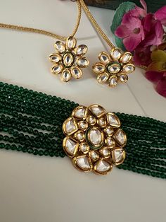 Discover the epitome of elegance with our premium necklace set. Crafted with precision and designed to turn heads, this set is a true masterpiece. Product Details: Material: Each piece is meticulously handcrafted from high-quality brass, Copper, Silver, Kundan Work, Green Beads, Premium Dori. Choker Necklace Dimensions: Weight: 55 grams. Closure Type: Premium Dori Adjustable Size: Yes Width of Choker: 4 cm.  Stud Earring Dimensions (Per Pair): Weight: 16 grams Diameter: 2.8 cm Closure Type: Push Back Closure Exquisite Design: This set boasts a design that's truly captivating, ensuring you stand out on any occasion. Compliment Magnet: Expect a shower of compliments every time you wear this stunning ensemble. Indulge in the finest craftsmanship with our necklace set. Elevate your style, make Heavy Elegant Gold-plated Kundan Necklace, Handmade Brass Jewelry For Party, Formal Green Plated Jewelry, Elegant Festive Metal Jewelry, Fusion Style Gold Jewelry Sets With Tilla, Ceremonial Kundan Jewelry With Elegant Design, Gold Fusion Jewelry Sets With Hand Set Details, Elegant Brass Necklaces With Tilla Detail, Elegant Brass Necklaces With Tilla