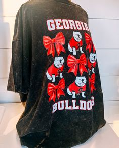 Georgia Bulldogs Dawg Bow • Oversized Tee Score a fashion touchdown with the Georgia Bulldogs Dawg Bow Oversized Tee! Show off your team spirit and style with this playful and comfy tee. Perfect for game days, tailgates, or any day you want to add a little dawg flair to your outfit. Go dawgs!