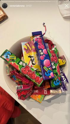 a bowl filled with candy on top of a table