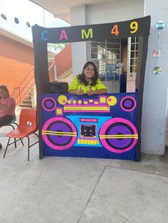 a woman sitting in front of a radio booth