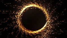 a black hole with yellow sparklers in it