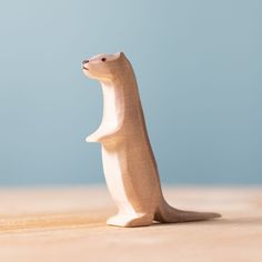 a wooden toy bear sitting on top of a table