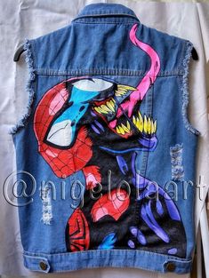 a jean jacket with an image of spiderman on it