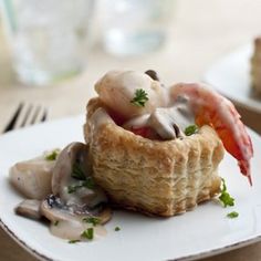 a plate topped with food on top of a wooden table