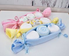 three different types of baby items on a white counter top next to a pink and blue bag