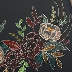 a painting of flowers on a black background