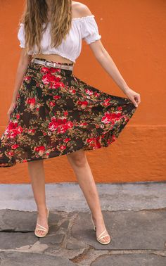 Embrace the effortless allure of summer with this captivating black floral skirt. Adorned with vibrant roses, it exudes a romantic charm, perfect for sunny days and balmy evenings. The elastic waistband ensures a comfortable fit, cinching gracefully to flatter your figure. Crafted from a delicately sheer material, it promises to keep you cool while offering a hint of mystique. Whether you're strolling through a garden or attending an outdoor soiree, this skirt will float around you, lightweight Fitted Rose Print Skirt For Summer, Casual Rose Print Summer Skirt, Casual Rose Print Skirt For Summer, Casual Summer Skirt With Rose Print, Outdoor Soiree, Sheer Midi Skirt, Black Floral Skirt, Sheer Material, Summer Skirts