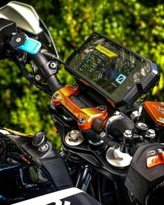 a close up of a motorcycle with a gps device on it's handlebars