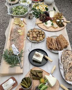 a table topped with lots of different types of food on plates and serving trays