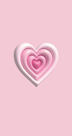 a pink heart shaped lollipop on a pink background