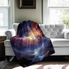 a couch with a blanket on it in front of a window filled with light and stars