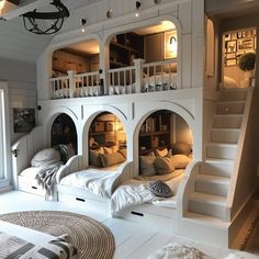 a room with bunk beds and stairs in it