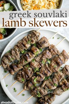 greek lamb skewers on a plate with rice and salad