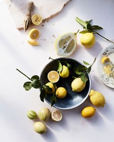 lemons and other fruit on a white surface