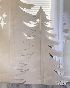 a christmas tree made out of plywood with white snowflakes