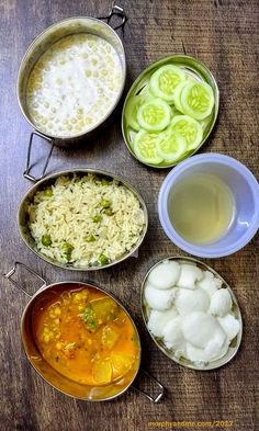 several bowls filled with food sitting on top of a wooden table