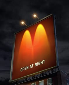 an open at night sign on top of a building