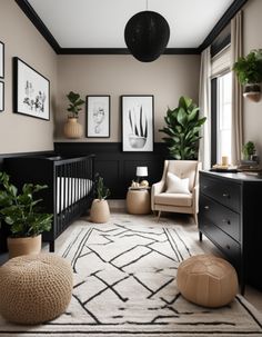 a baby's room with black and white decor, potted plants and pictures on the wall