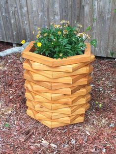 a planter made out of wooden blocks on the ground