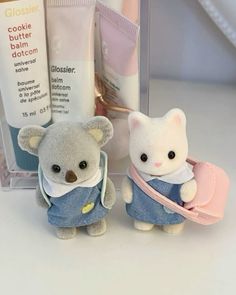 two small stuffed animals sitting next to each other