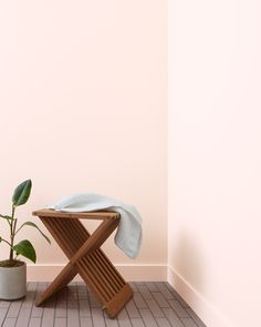 a chair with a towel on it next to a potted plant