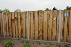 a wooden fence with two butterflies painted on it