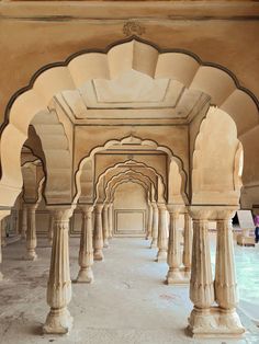 an archway in the middle of a building with pillars and arches on both sides,