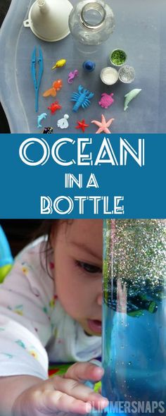 the ocean in a bottle is filled with sand and seaweed, while a baby looks at it