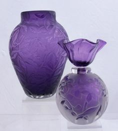 two purple vases sitting next to each other