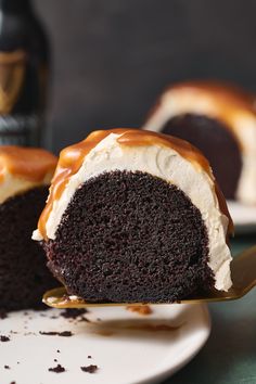 a chocolate bundt cake with caramel drizzled on top and frosting