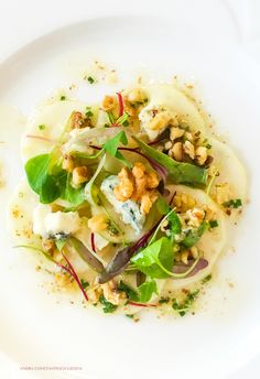 a white plate topped with food and veggies on top of it's side