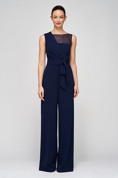 The Aubree Jumpsuit, crafted from stretch scuba crepe, offers versatile elegance with its sleeveless design, asymmetric overlay bodice, and sheer yoke. The palazzo pants, oversized decorative bow at the waistband, and timeless navy hue make it a chic choice for both formal and semi-formal occasions. Details Asymmetric Neck Jumpsuit Silhouette Wide Leg Sleeveless Floor Length Knit REF: 86411860 Dark Blue Jumpsuit Formal, Navy Pantsuit Women, Formal Pantsuit, Semi Formal Wedding Attire, Dark Blue Jumpsuit, Formal Wedding Guest Attire, Bow Jumpsuit, Office Party Outfits, Wedding Attire For Women