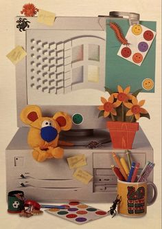 an image of a stuffed animal sitting on top of a printer with flowers and other items