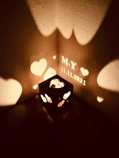 a light that is on top of a box in the middle of a room with hearts