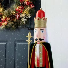 a large nutcracker is standing in front of a door