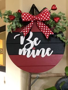 a sign that says be mine hanging on the wall