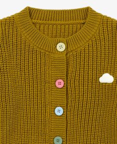 Designed with comfort in mind, this Knit Cardigan in Turmeric will help your little one stay cozy this Fall/Winter. Made from 100% merino wool, a natural and eco-friendly material, this lightweight cardigan is soft, hypoallergenic, and will keep your child warm while they're out on their adventures. This cardigan has a crew neck cut with an adorable cloud motif in the front, a tribute to your little daydreamer. Made with a relaxed fit, this chunky knit cardigan It has textured finish and ribbed