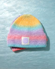 Brighten up chilly days with Daily Disco's Rainbow Ombre Beanie! This vibrant, eye-catching beanie features a seamless blend of rainbow colors, making each piece uniquely different. Crafted from a cozy and durable cotton-acrylic blend, it offers both comfort and style for any winter ensemble. The ombre effect of the yarn ensures that no two beanies are exactly alike. Get ready to turn heads and brighten moods with this delightful addition to your winter wardrobe! Trendy Multicolor Fall Hat, Multicolor Beanie For Outdoor, Trendy Multicolor Winter Beanie, Multicolor Beanie For Fall, Trendy Multicolor One Size Beanie, Trendy Multicolor Winter Hats, Trendy Multicolor Cotton Hats, Multicolor One Size Beanie For Outdoor, Multicolor One-size Beanie For Outdoor