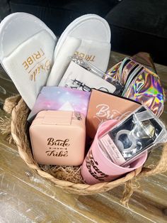 a basket filled with lots of different items on top of a wooden table next to a pair of slippers