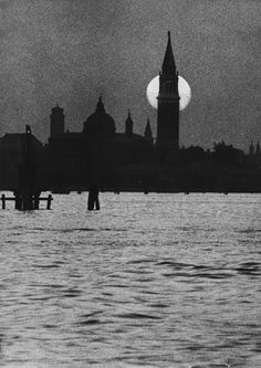 a large body of water with a clock tower in the background