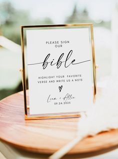 a table with a sign that says please sign our bible, highlight your favorite verse and write us a note