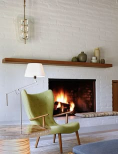 a living room filled with furniture and a fire place in the middle of the room