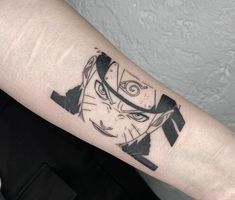 a black and white tattoo on the arm of a person's arm with an evil face