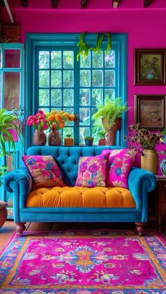 a living room filled with colorful furniture and lots of potted plants on the windowsill