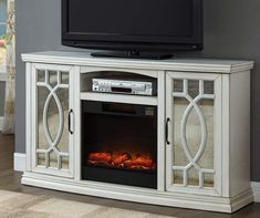 an entertainment center with a television and fire place