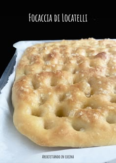 a close up of a pastry on a piece of wax paper with the words focaccia di locatellelli